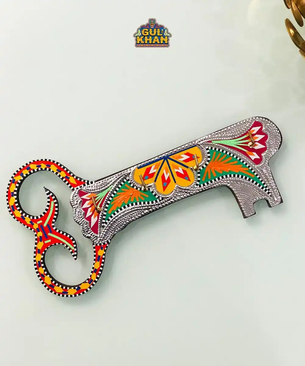 Handcrafted colorful wall key holder with traditional floral and geometric patterns by Gul Khan