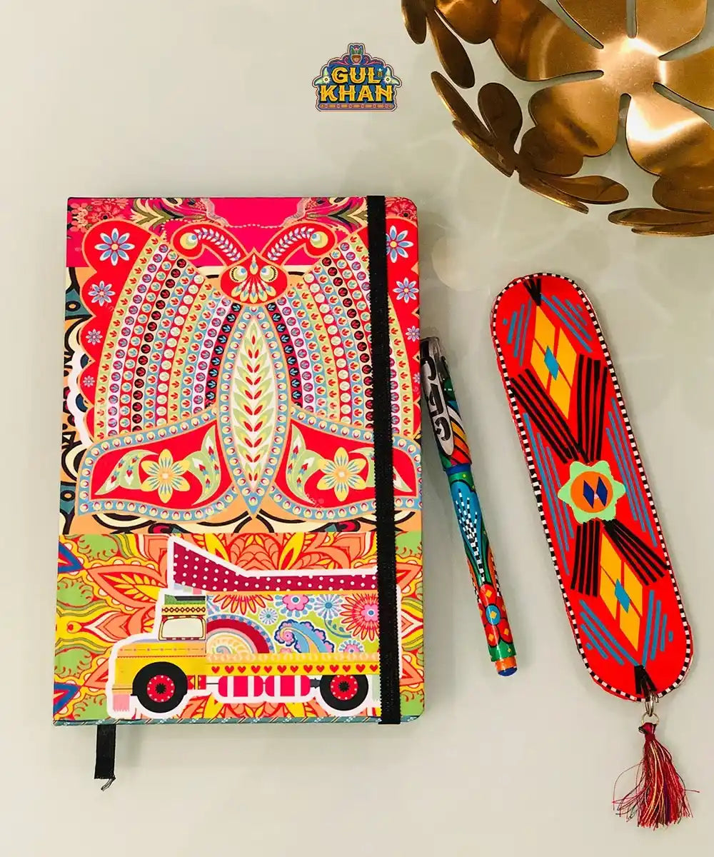Colorful Gul Khan notebook with butterfly and truck design, matching pen, and vibrant bookmark on white surface