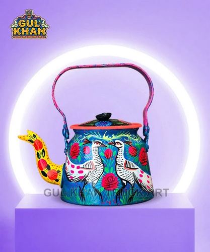 Colorful hand-painted kettle with bird and floral motifs on purple pedestal, glowing white circular backdrop