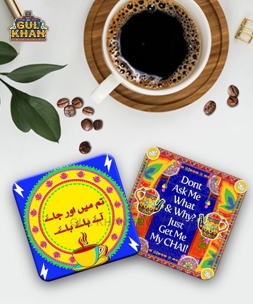 Coffee cup on wooden coaster with two colorful tea coasters featuring tea quotes and designs